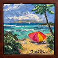 A framed square Hawaii oil painting depicting a tropical Maui beach scene in Kapalua with turquoise ocean waves, a sandy shore, a red and yellow beach umbrella, green palm foliage, and a dark brown wooden frame. The artist's signature 'Michael Stark' is visible in the bottom right corner.